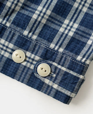 Blue plaid shirt jacket cuff with two white buttons and stitched hem