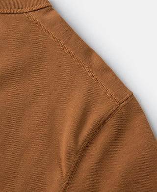 Long-sleeve henley shirt shoulder seam and ribbed cuff detail in orange