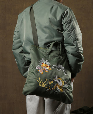 Olive bomber-style tote bag with dragon and tiger embroidery on the front panel