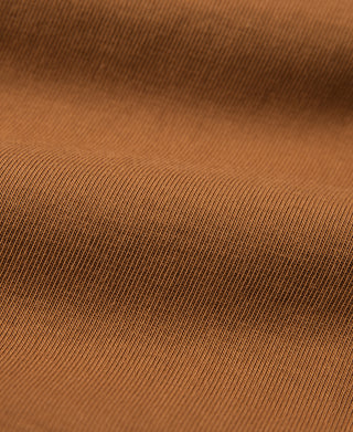 Orange henley shirt knit fabric close-up with fine ribbed texture
