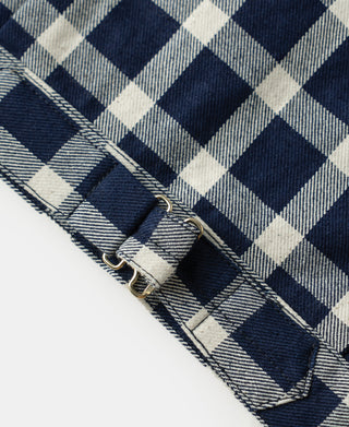 Plaid work jacket cuff with metal grommets and strap hardware detail