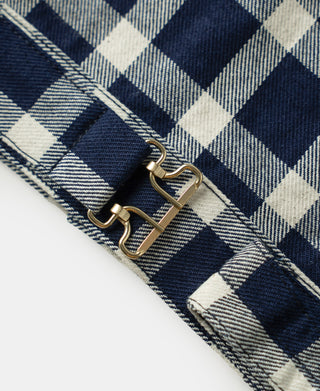 Plaid work jacket cuff with two metal buckles and grommets on strap