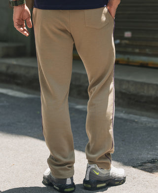 Khaki waffle knit jogger pants on model, tapered leg and stitched seams