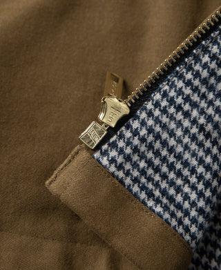 Brown cossack jacket zipper close-up with gold-tone pull