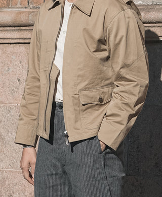 Khaki flight jacket with front zipper and flap chest pockets; rib-knit cuffs
