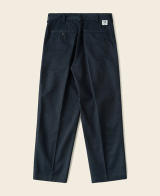 Navy cotton twill trousers with belt loops, front pleats, and side pockets