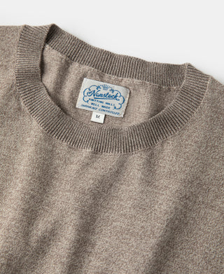 Ribbed crew neckline and brand tag on light brown heather jersey T-shirt