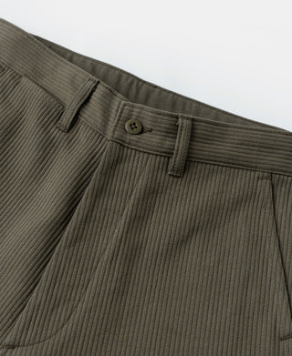 Cotton trousers waistband detail with button closure, belt loops, and vertical pique stripes.