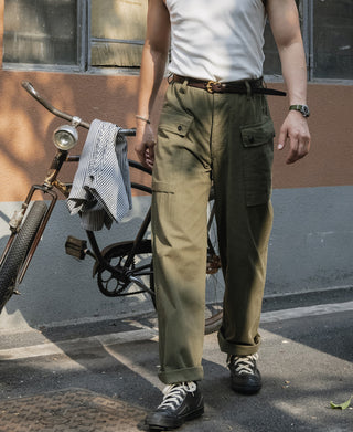 Brown leather belt with brass buckle worn on waist