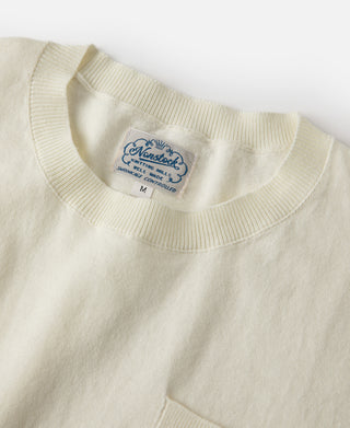 Light cream T-shirt with ribbed crew neck and blue size label on chest