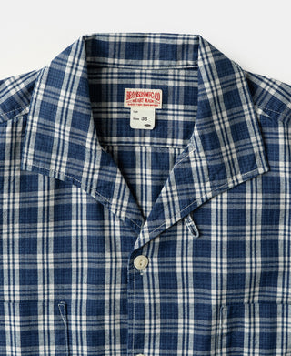 Blue plaid camp-collar shirt jacket with button placket and label at neckline