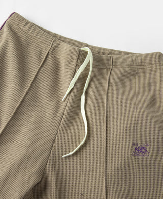 Khaki jogger pants with white drawstring and side logo on the thigh