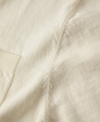 Light cream jersey knit T-shirt with visible side seam and knit texture detail