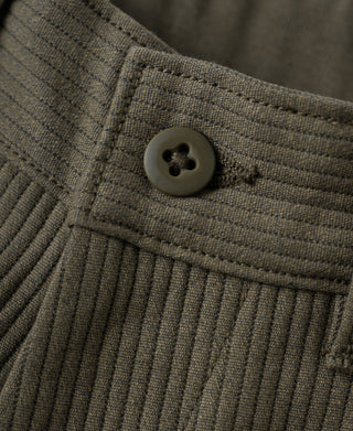 Trouser waistband and button detail with vertical pique stripes, dark coffee cotton.