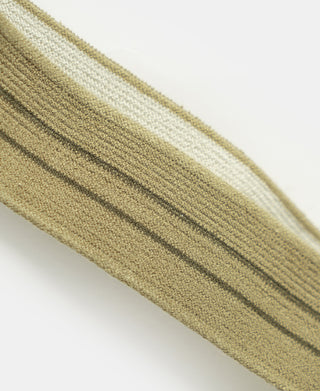 Khaki striped woven suspender fabric with textured detail and seams