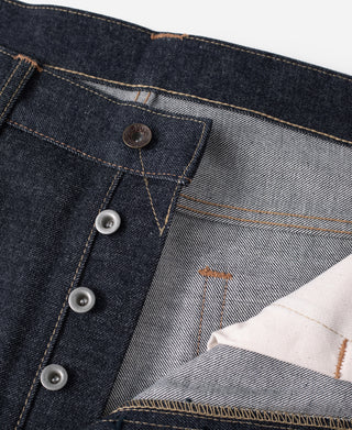 Denim jeans interior waistband with layered pocket lining and metal button closure