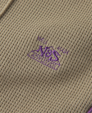 Khaki waffle-knit fabric with small purple embroidered logo on the leg