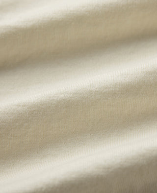 Light cream jersey knit fabric close-up showing fine texture and weave