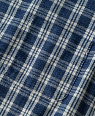 Blue and white plaid shirt fabric with curved pocket edge stitching