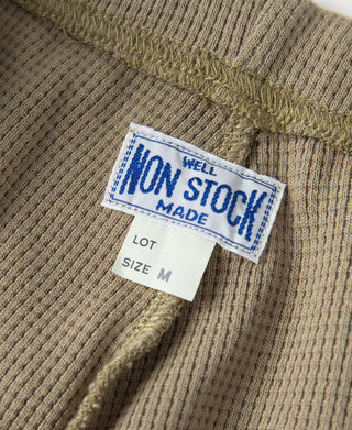 Khaki waffle-knit jogger pants with size M tag on the inner waistband