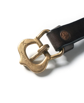 Brown leather belt buckle close-up with antique brass hardware