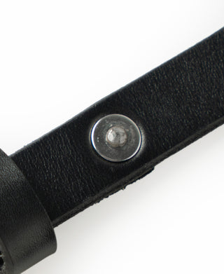 Black leather belt with silver-tone round rivet keeper close-up