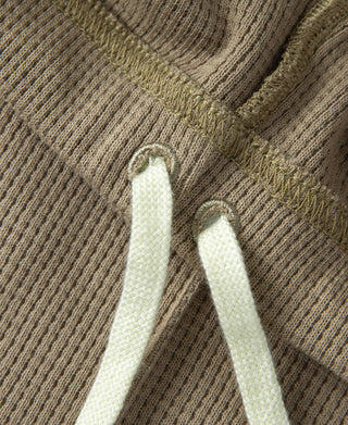 Khaki waffle-knit jogger pants with elastic waistband and stitched drawstring eyelets