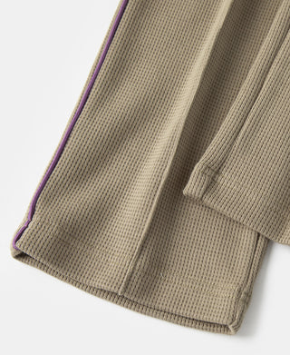 Khaki jogger pants with ribbed cuffs and a purple side stripe along the seam