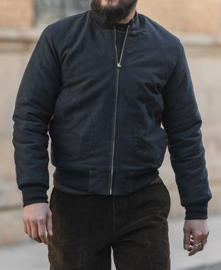 Navy deck jacket with zipper front, curved chest pockets, and ribbed cuffs