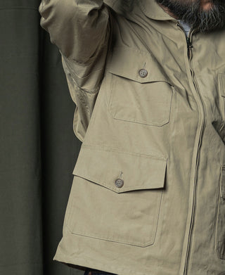 Khaki flight jacket with buttoned pocket flaps and front zipper closure on chest