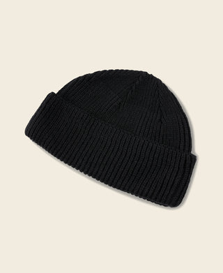 Black knit watch cap with folded cuff, angled view