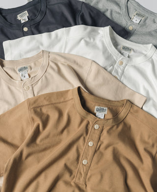 Henley T-shirts in dark gray, white, and tan with button plackets